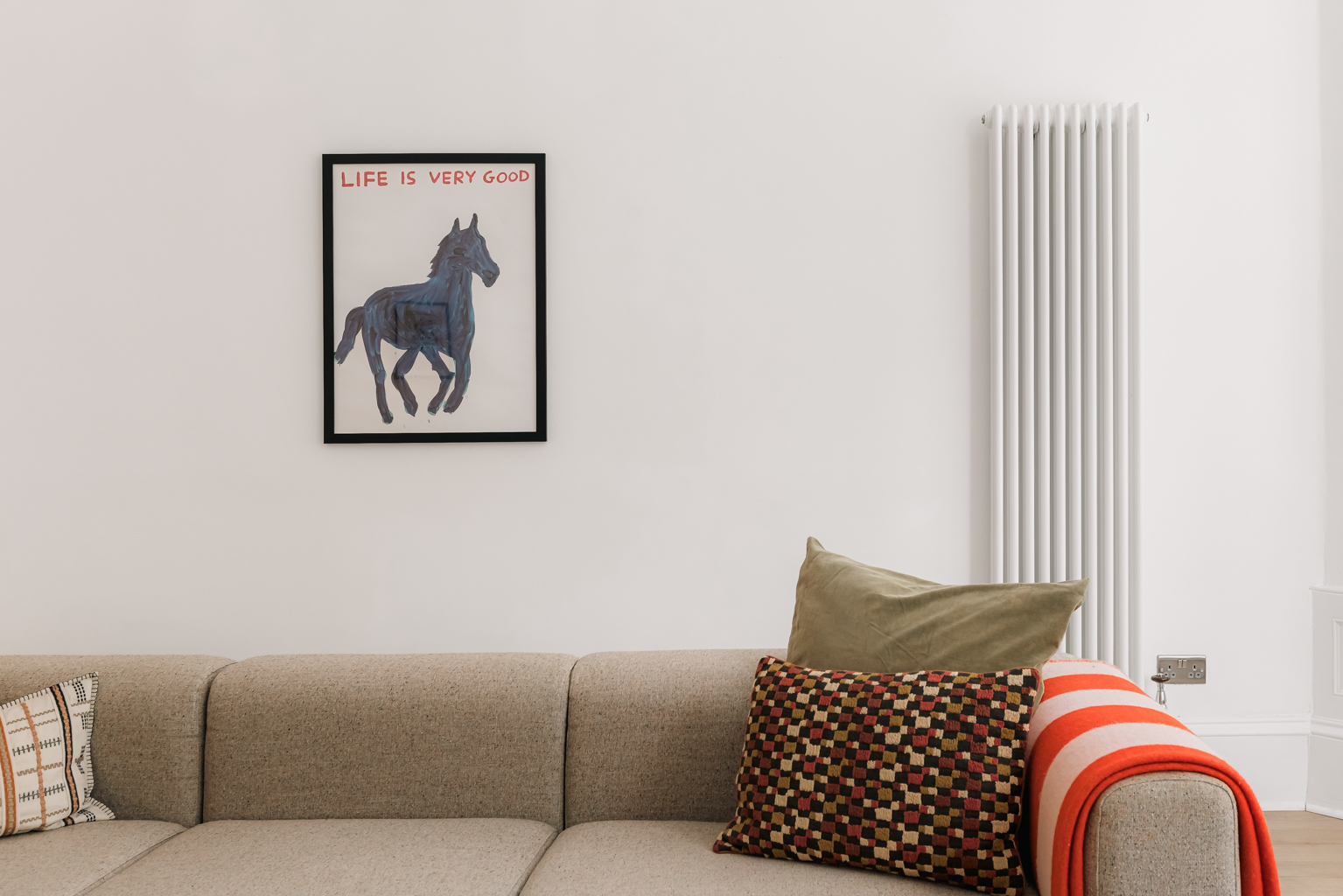 Professionally styled lounge in a Yates Hellier managed rental property in Glasgow's West End, with a beige corner sofa, patterned cushions and framed artwork