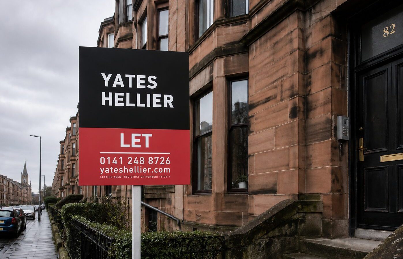 Yates Hellier letting board outside a traditional Glasgow sandstone tenement on a residential street in the West End