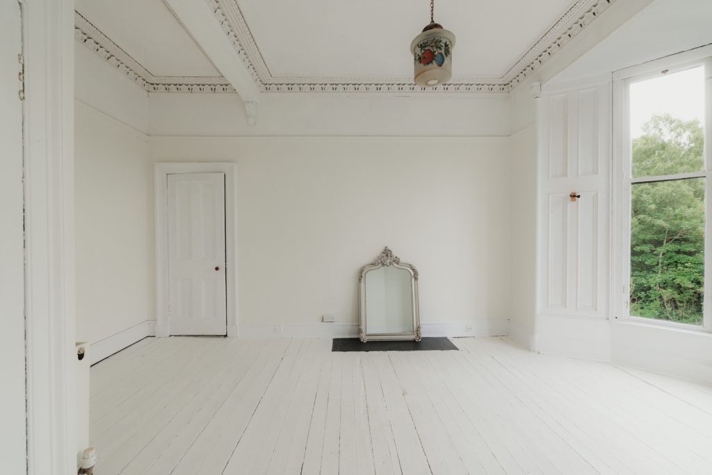 Elegant period room within Janefield Cottage featuring original decorative cornicing, painted timber floors, sash windows and views towards the River Kelvin.