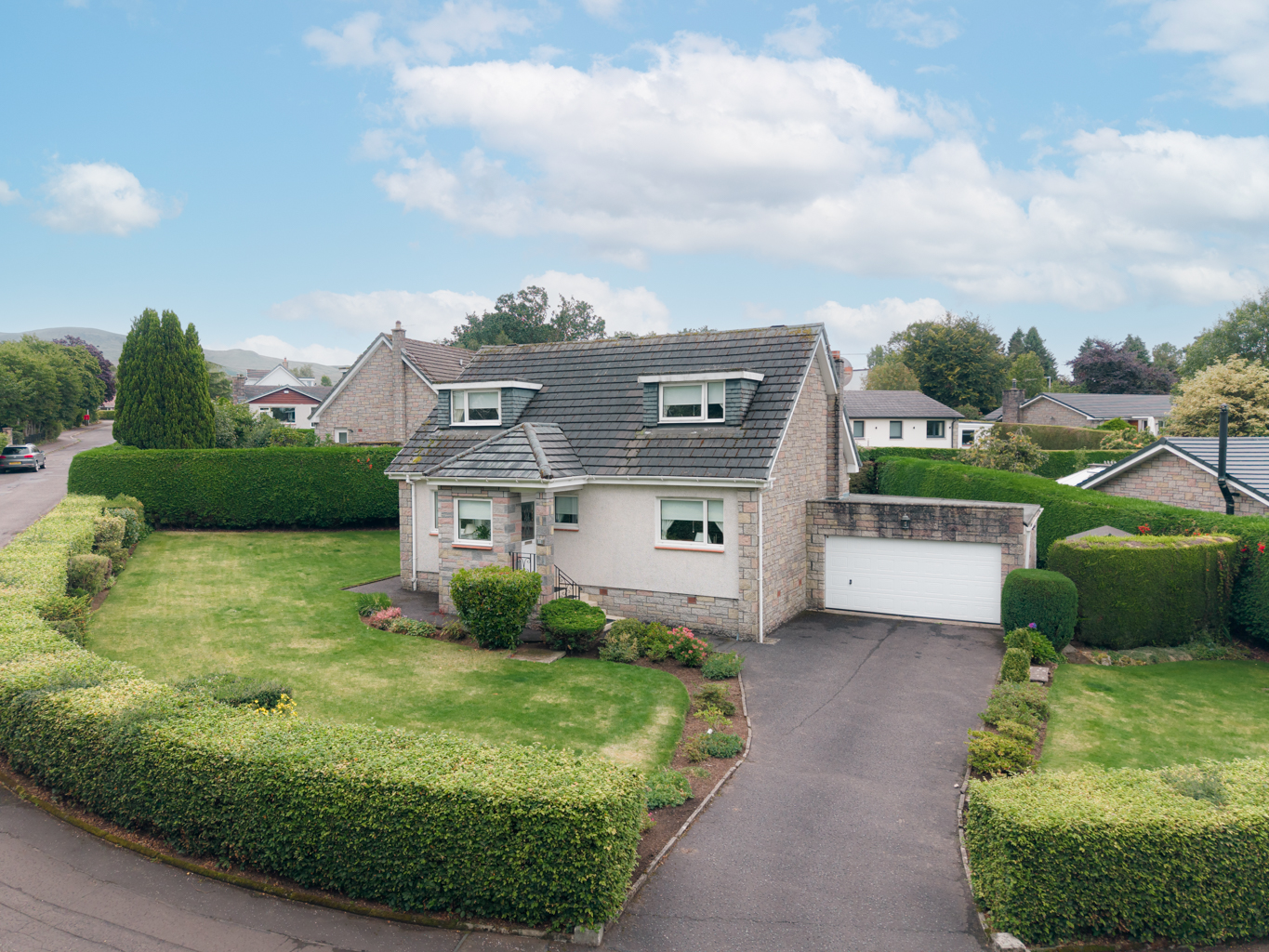 Detached family home for sale on Lampson Road, Killearn, with double garage and private corner garden plot